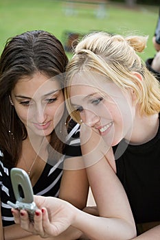 Friends on Cell Phone together (Beautiful Young Blonde and Brunette Girls)