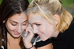 Friends on Cell Phone together (Beautiful Young Blonde and Brunette Girls)