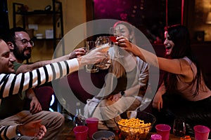 Group of friends toasting drinks together during a