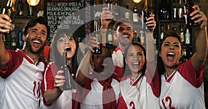 Friends cheering while having beer at bar counter