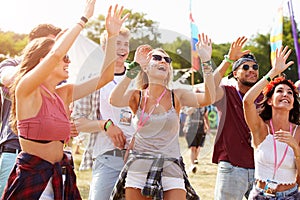 Friends cheering a performance at a music festival