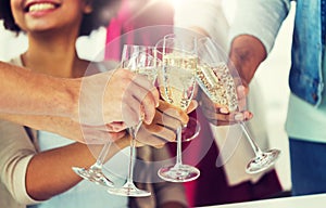 Friends clinking glasses of champagne at party