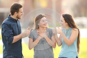 Friends congratulating a happy girl in the street