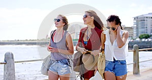 Friends, conversation and bonding together at beach, communication and relax on ocean vacation. Women, sisterhood and