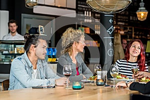 Friends Conversing While Having Food At Restaurant photo