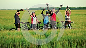 Friends cyclists waving in camera