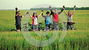 Friends cyclists waving in camera