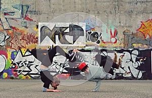 Friends dancing breakdance on the street