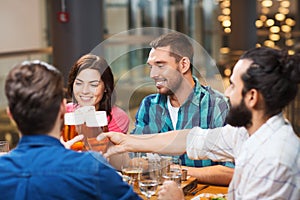 Friends dining and drinking beer at restaurant