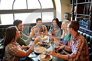 Friends dining and drinking beer at restaurant