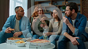 Friends drinkers ethnic caucasian african american women and men drinking beer celebrate at home festive table eating