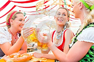 Friends drinking Bavarian beer at Oktoberfest