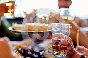 Friends drinking beer at bar or pub