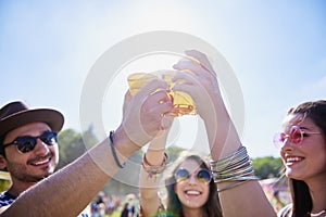 Friends drinking beer and having fun in festival