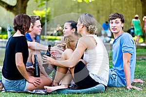 Friends drinking beer at lake