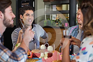 Friends drinking beer in pub