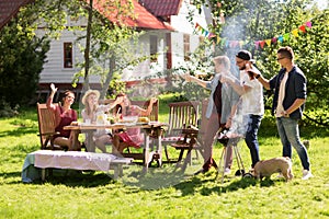 Friends drinking beer at summer barbecue party