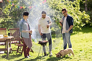 Friends drinking beer at summer barbecue party