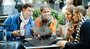 Friends drinking coffee outdoors