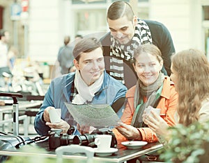 Friends drinking coffee outdoors