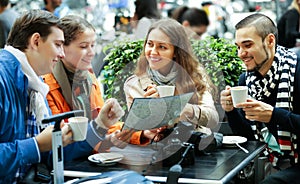 Friends drinking coffee outdoors