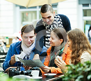 Friends drinking coffee outdoors