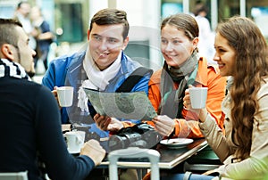 Friends drinking coffee outdoors