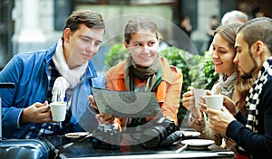 Friends drinking coffee outdoors