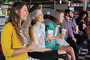 Friends drinking smoothie at restaurant