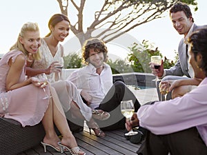 Friends Drinking And Socialising On Porch