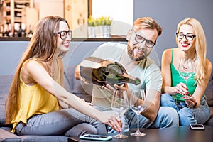 Friends drinking wine at home