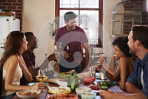 Friends with drinks at the table during a dinner party