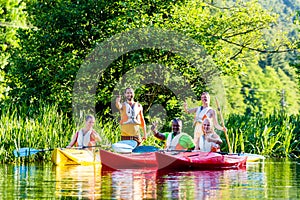 Friends driving with kayak on river