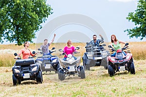 Friends driving off-road with quad bike