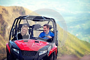 Friends driving off-road with quad bike or ATV and UTV vehicles