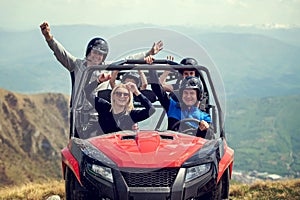 Friends driving off-road with quad bike or ATV and UTV vehicles photo