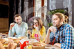 Friends eating asian meals at the restaurant