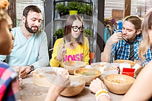 Friends eating asian meals at the restaurant