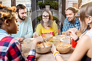 Friends eating asian meals at the restaurant