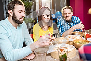 Friends eating asian meals at the restaurant