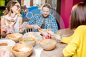 Friends eating asian meals at the restaurant