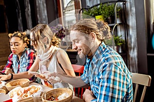 Friends eating asian meals at the restaurant