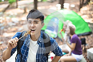 Friends eating barbecue and having fun cheering