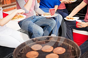 Friends eating burgers at a barbecue