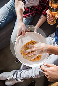 Friends eating crisps