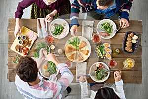 Friends Eating at Dinner Table photo