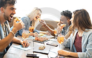 Friends eating and drinking spritz at fashion cocktail bar restaurant - Friendship concept with young people having fun together