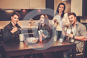 Friends eating fast food at home