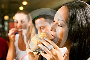 Friends eating fast food in a restaurant