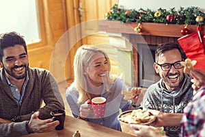 Friends eating gingerbread Christmas cookies on Christmas morning